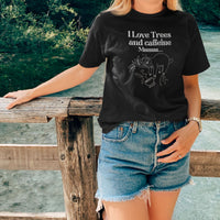 Woman wearing I Love Trees and Caffeine Black Unisex Cotton T-Shirt standing on the bridge