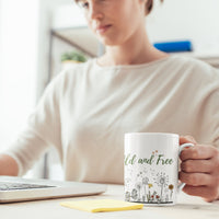 All Good Things are Wild and Free - Woman holding a Flower Design Mug working in front of the desk